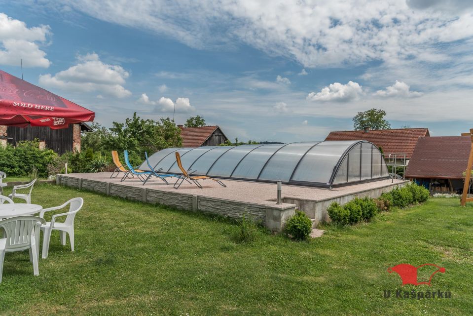 Covered pool with loungers and garden seating