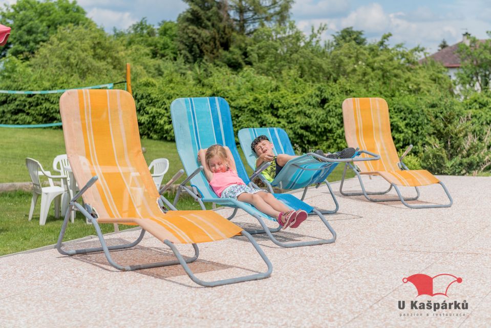 Children on sun loungers in the guesthouse garden