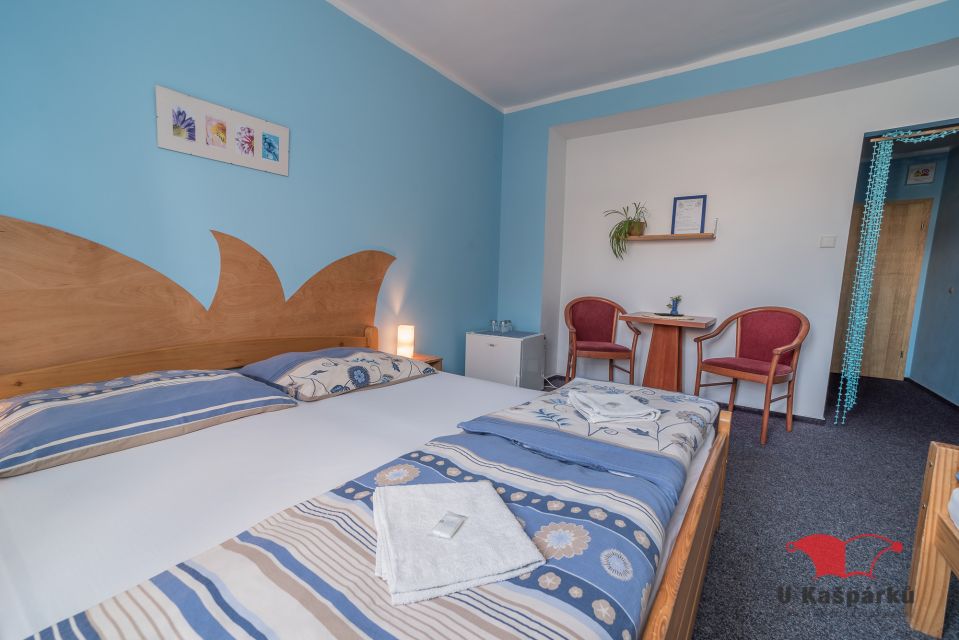 Bright room with a wooden bed and a table by the window