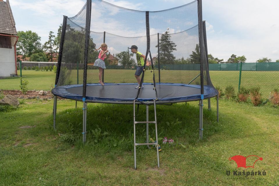Children on the large trampoline in the guesthouse garden