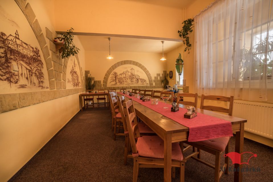 A long laid table in the hall with a wall mural